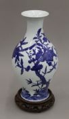A Chinese porcelain blue and white baluster shaped peach vase, with six character mark to base,