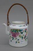 A 19th century Chinese porcelain teapot. 13 cm high excluding handle.