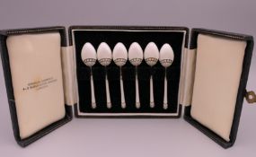 A boxed set of silver gilt white enamel coffee spoons, Birmingham 1949.