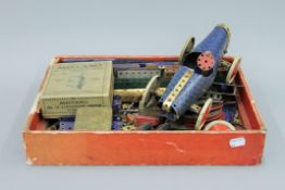 A box of early blue Meccano and a boxed clockwork motor.