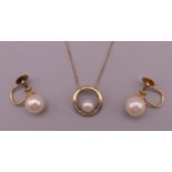 A 9 ct gold and pearl pendant set with small diamonds on a fine 9 ct gold chain and a pair of 9 ct