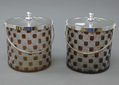 A pair of silver plated and cut glass biscuit barrels. 15 cm high excluding handles.