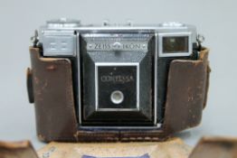 A vintage Zeiss Ikon Contessa camera, cased.