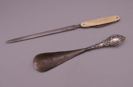 A silver handled shoe horn and a paperknife.