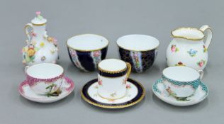 A pair of 19th century German porcelain miniature teacups and saucers,