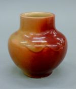 A small glazed stoneware vase. 11 cm high.