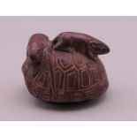 A netsuke formed as a tortoise and rats. 4 cm long.