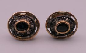 A pair of unmarked gold sapphire and diamond cluster earrings. 2.2 cm high. 4.