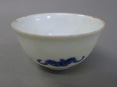 A Chinese blue and white porcelain tea bowl decorated with bats. 8 cm diameter.