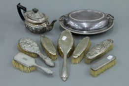 A silver teapot, seven silver backed brushes and a plated entree dish.