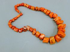 A coral necklace. 51 cm long.