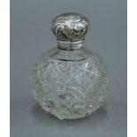 A silver topped cut glass scent bottle. 9.5 cm high.