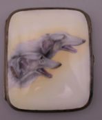 An Alpaca and enamel cigarette case decorated with two Borzoi dogs. 7.5 cm wide.