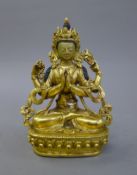 A 19th century gilt bronze painted faced deity. 14 cm high.