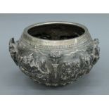 A 19th century Burmese Imperial silver bowl, with six finely worked repousse scenes,