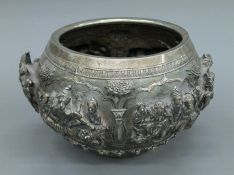 A 19th century Burmese Imperial silver bowl, with six finely worked repousse scenes,