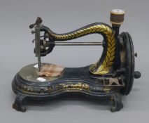 An early Joans and Co gilt decorated sewing machine. 40 cm long.