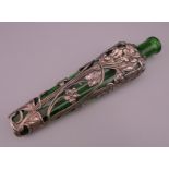 A silver clad green glass scent bottle with Art Nouveau stylized flowers. 20 cm high.