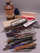 A collection of various fountain pens, pencils, pots of ink, etc.