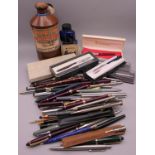 A collection of various fountain pens, pencils, pots of ink, etc.