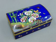 A cloisonne rectangular box with domed lid. 13.5 cm wide.