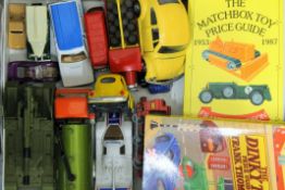 A collection of various die cast vehicles and catalogues.