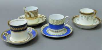 Four various coffee cans and saucers.