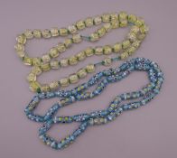 Two strings of Italian glass beads.