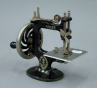 A miniature vintage Singer sewing machine. 16.5 cm high.