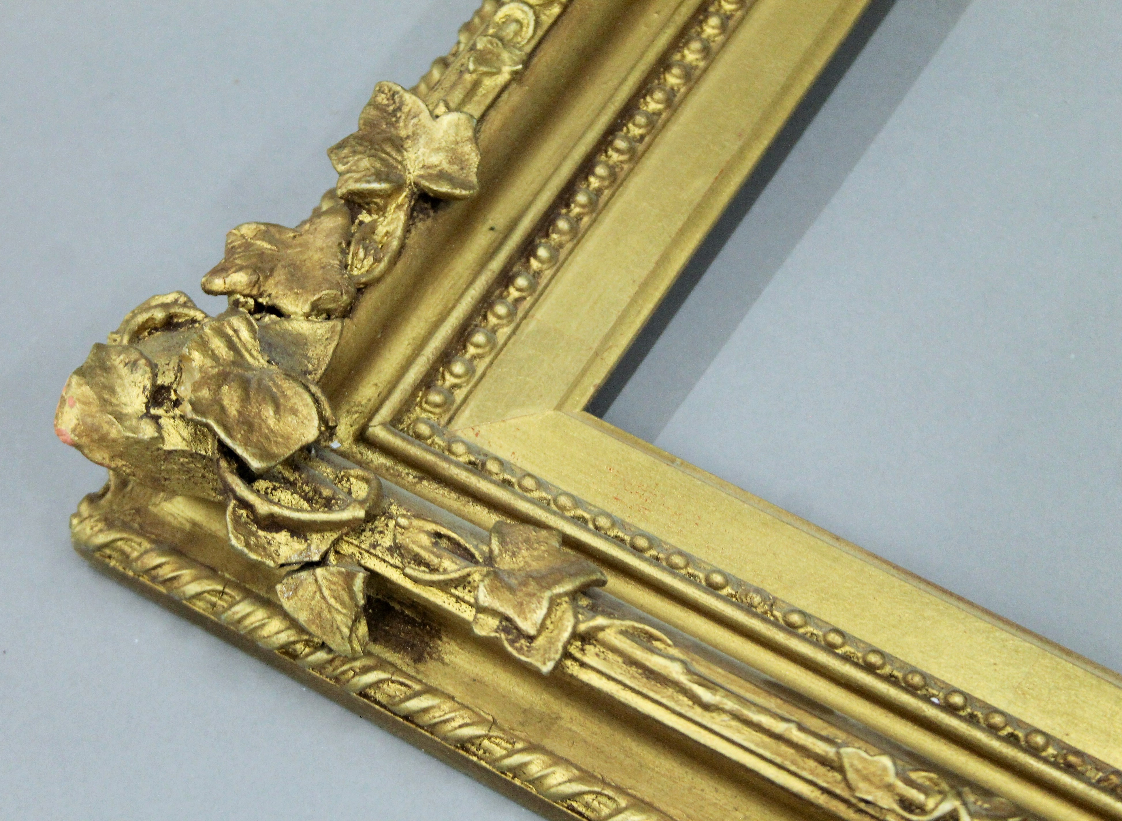 A Victorian gilt picture frame decorated with foliage. 65 x 53 cm exterior dimensions. 49 x 36. - Image 2 of 3
