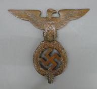 A patinated bronze Nazi staff top. 17.5 cm high.