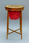 An Edwardian octagonal satinwood sewing table with hand painted decoration. 37 cm wide.