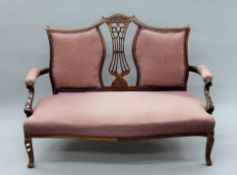 An Edwardian parlour settee. 130 cm wide.