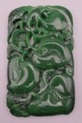 A large rectangular pierced jade tablet. 12 cm high.