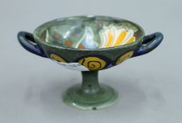 A small pottery twin handled tazza, the underside inscribed Liberty and Co Made in Holland.