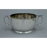 A small silver two handled bowl, hallmarked for Sheffield 1915 Edward and Sons. 6 cm high. 4.