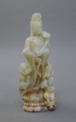 A jade figure of Guanyin and a boy. 14 cm high.