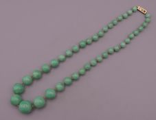 A string of jade beads. 44 cm long.