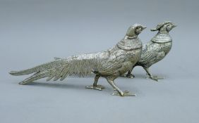 A pair of silver plated models of pheasants.