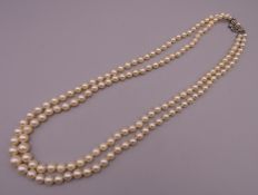 A two strand pearl necklace. 52 cm long.