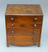 A Georgian mahogany miniature chest of drawers. 31 cm wide.