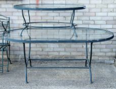 Two metal glass topped garden tables and six matching chairs.