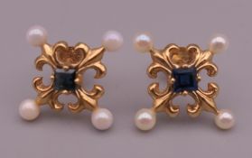 A pair of 14 K Faberge for Franklin Mint sapphire and seed pearl earrings. 1.2 cm wide.