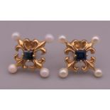 A pair of 14 K Faberge for Franklin Mint sapphire and seed pearl earrings. 1.2 cm wide.