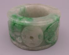 A carved jade serviette ring. 3 cm high.