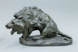 ANTONIO AMORCASTI (1880-1942), a bronze patinated plaster model of a lion. 28 cm high.