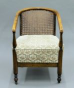 An early 20th century caned open armchair. 51 cm wide.