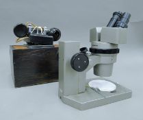 A vintage internal telephone and a microscope.