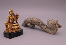 A jade dragon belt hook and a small gilt Buddha figure. The former 11 cm high.