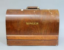 A cased Singer sewing machine.